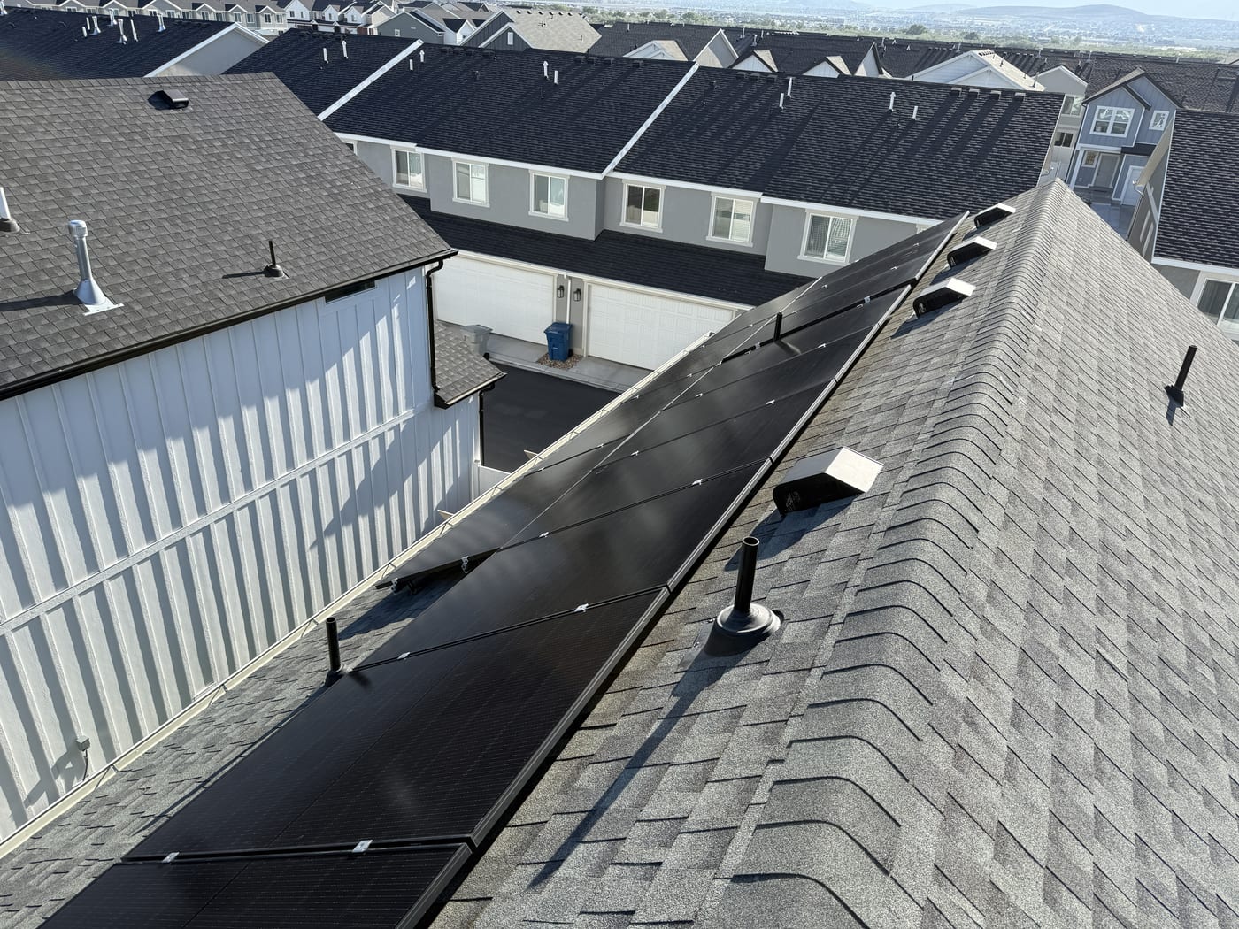 Underside angle of solar panels on roof showing racking hardware