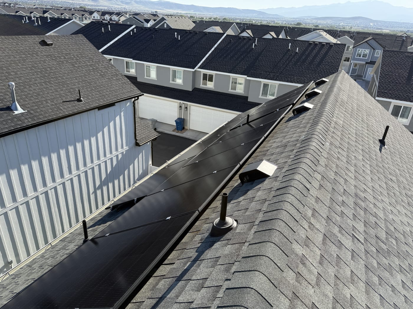 Underside view of solar panels on multi-section residential roof