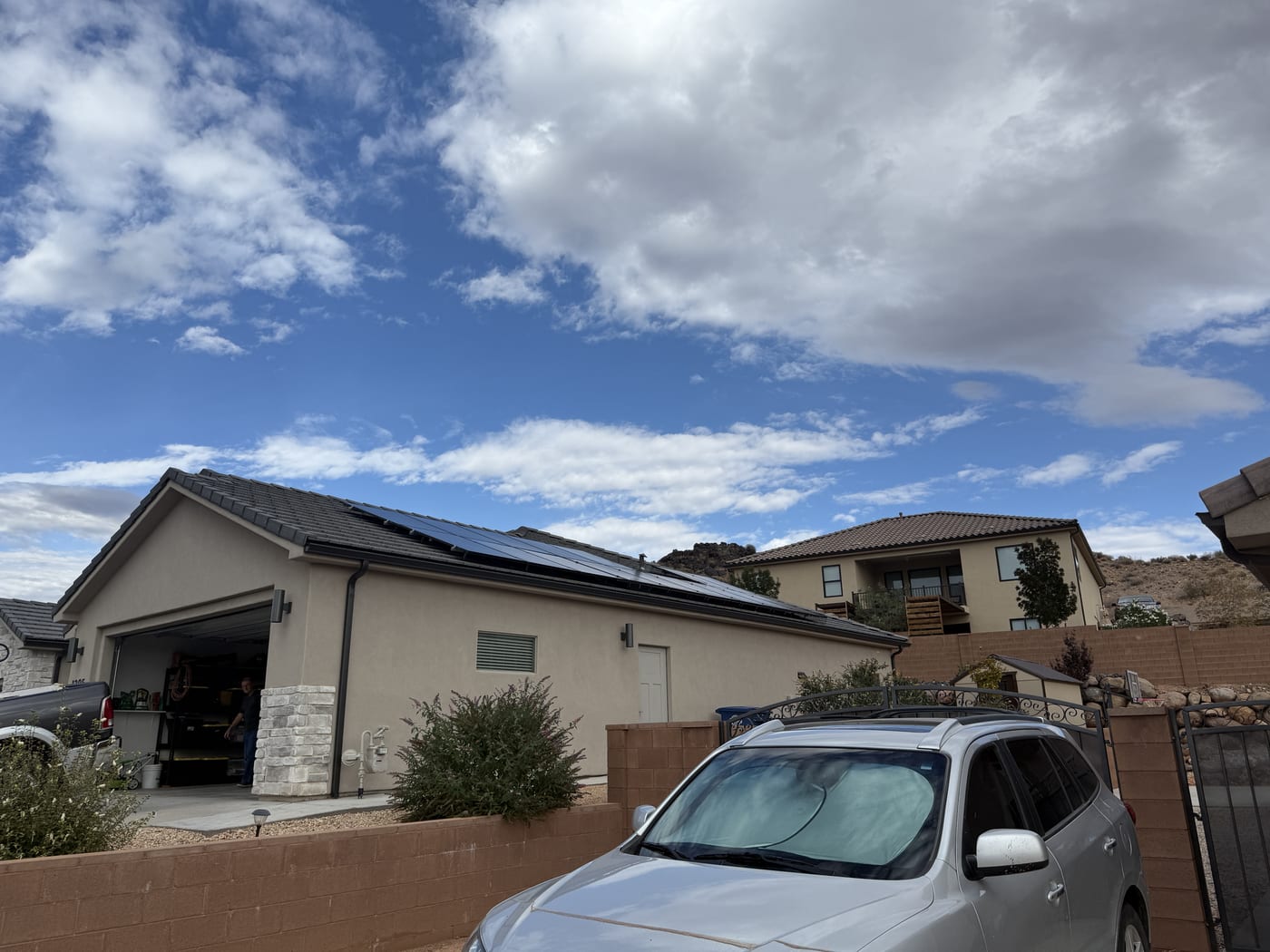 House exterior with truck in driveway and desert neighborhood landscape in Toquerville Utah