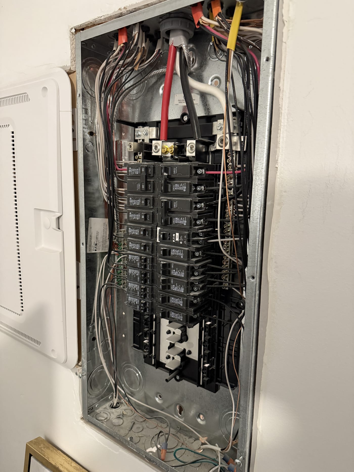 Open main breaker panel showing circuit breakers and wiring for solar interconnection