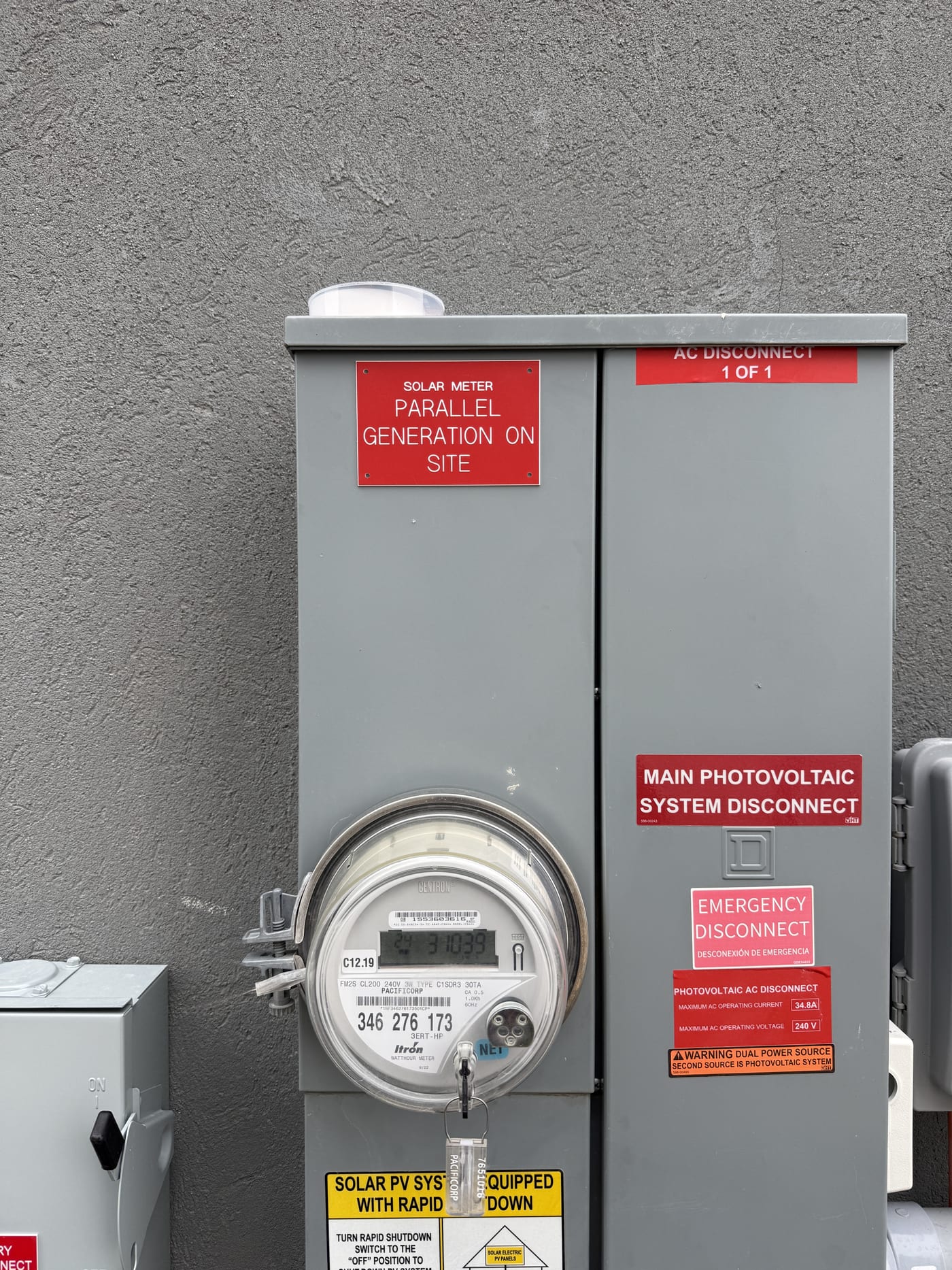 Close-up of meter with Parallel Generation On Site and Main Photovoltaic System Disconnect labels
