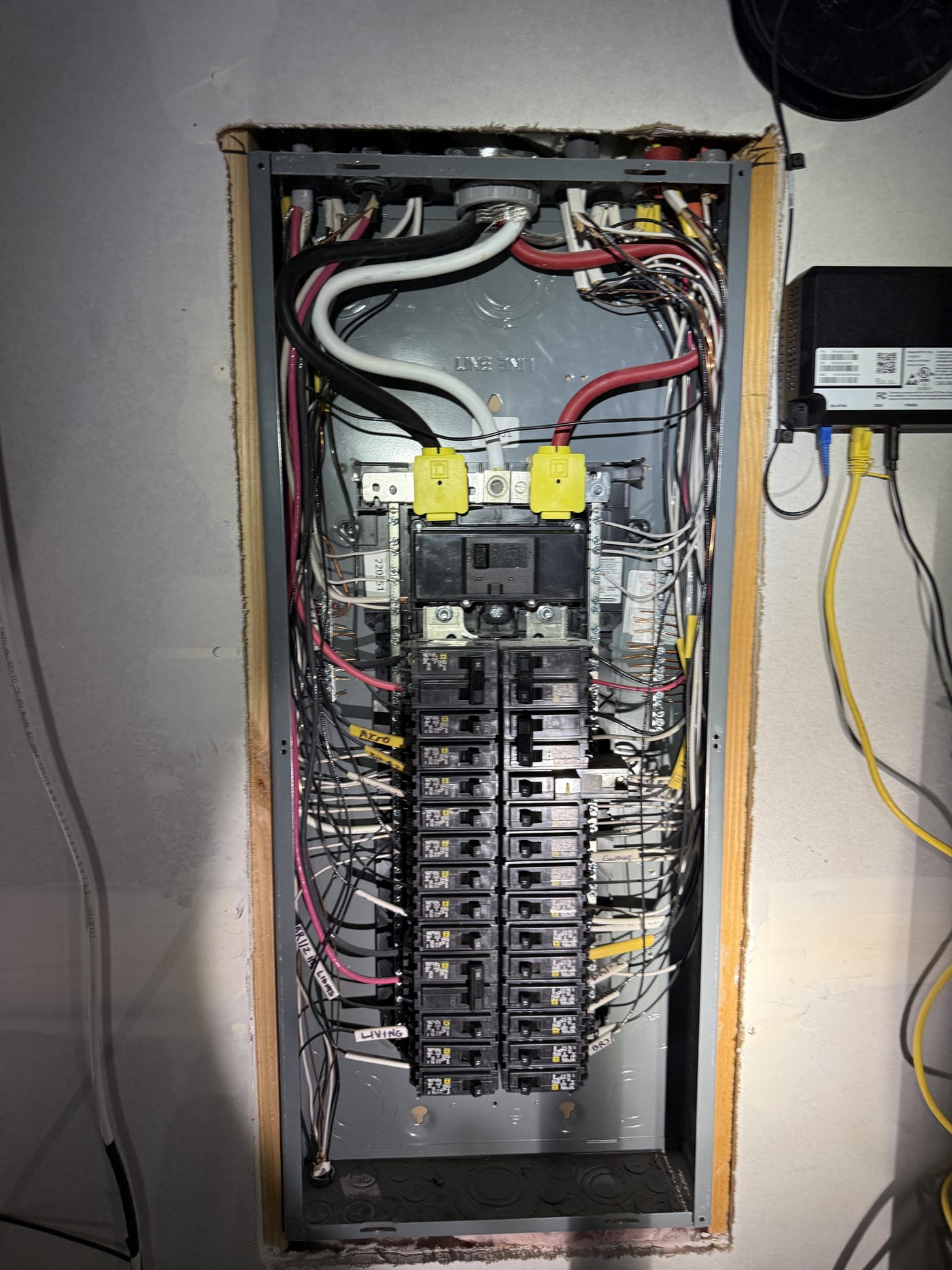 Main breaker panel opened showing all circuit breakers and wiring for solar interconnection